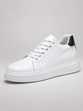 Men's white and black leather trainers, studio view