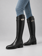 Women’s Knee High Leather Look Riding Boots – Buckle Detail Flat Boots — model-worn studio view